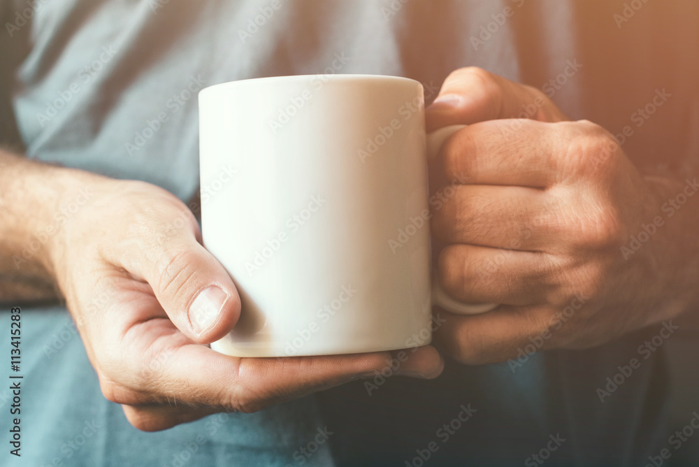 White coffee cup in male hands White coffee cup in male hands