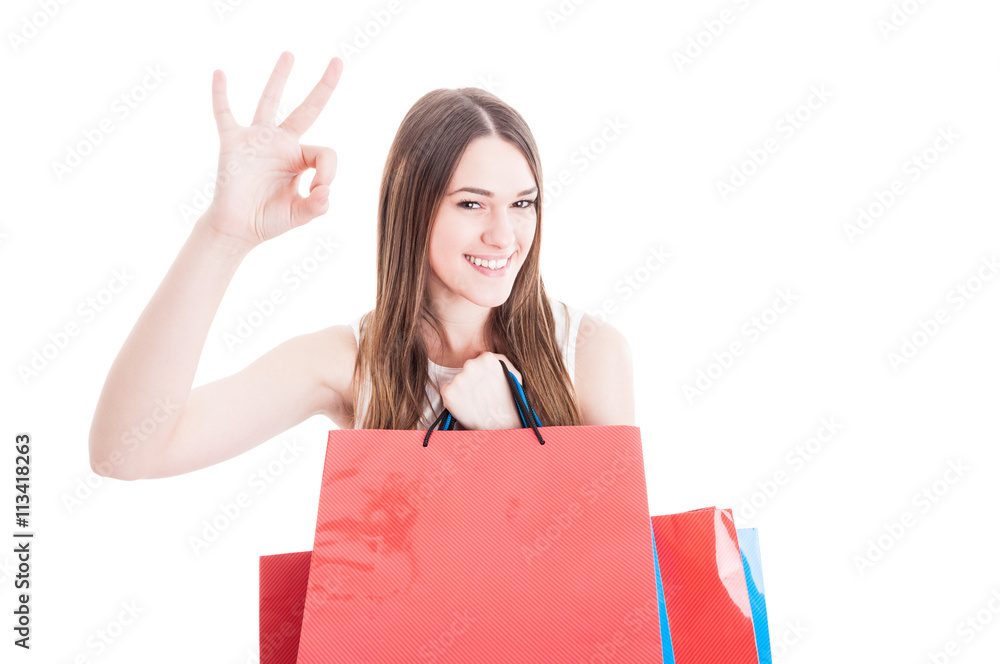 Happy friendly girl doing shopping and showing ok sign Happy friendly girl doing shopping and showing ok sign