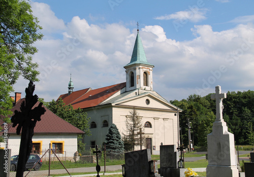 church in Skalice and some crosses on the cemetery at the foreground, Czech Republic photo