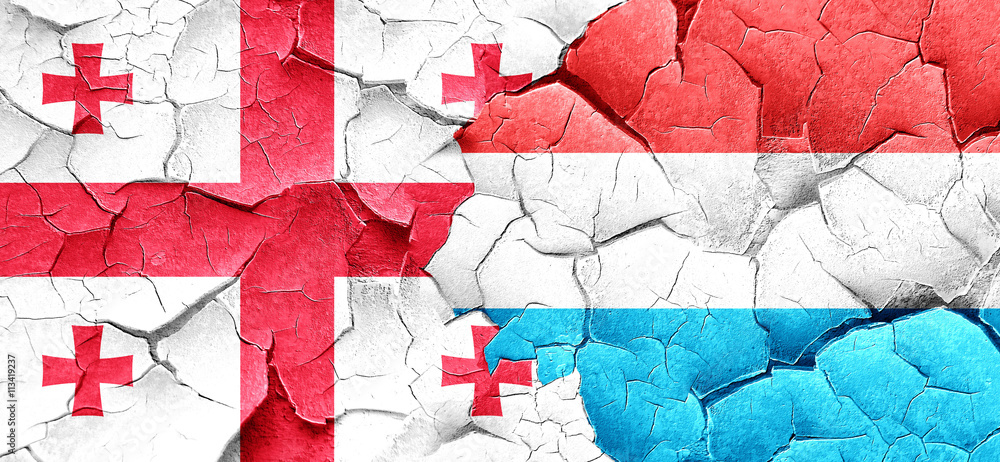 Georgia flag with Luxembourg flag on a grunge cracked wall