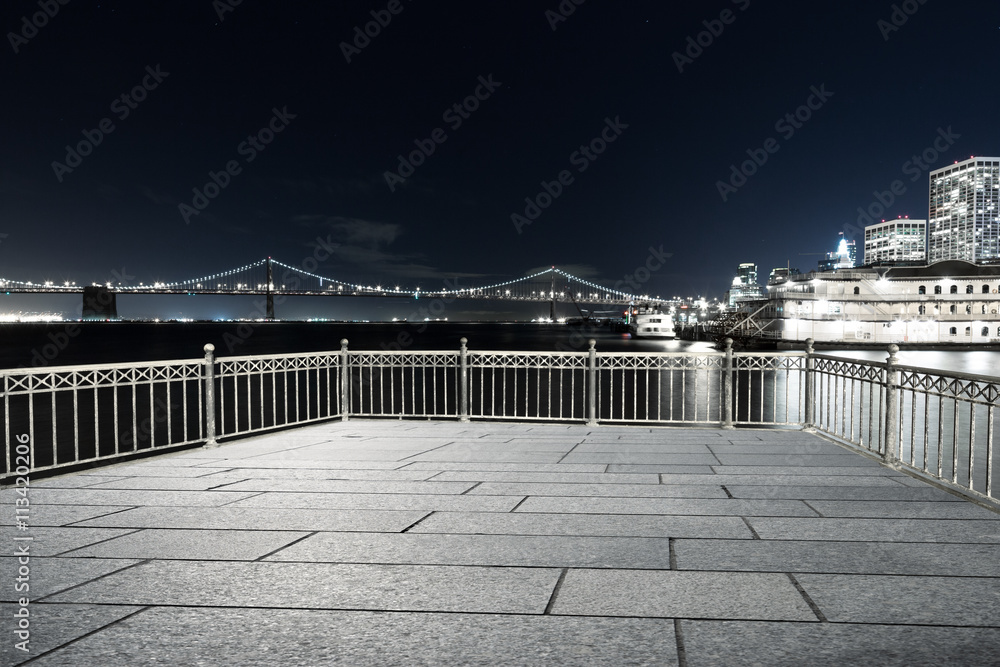 empty floor with suspension over water in san francisco at night