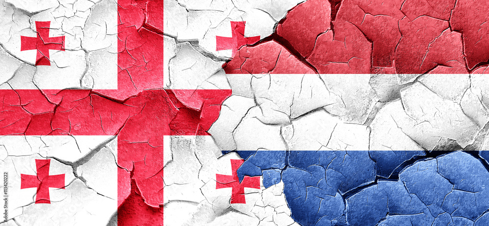 Georgia flag with Netherlands flag on a grunge cracked wall Georgia flag with Netherlands flag on a grunge cracked wall