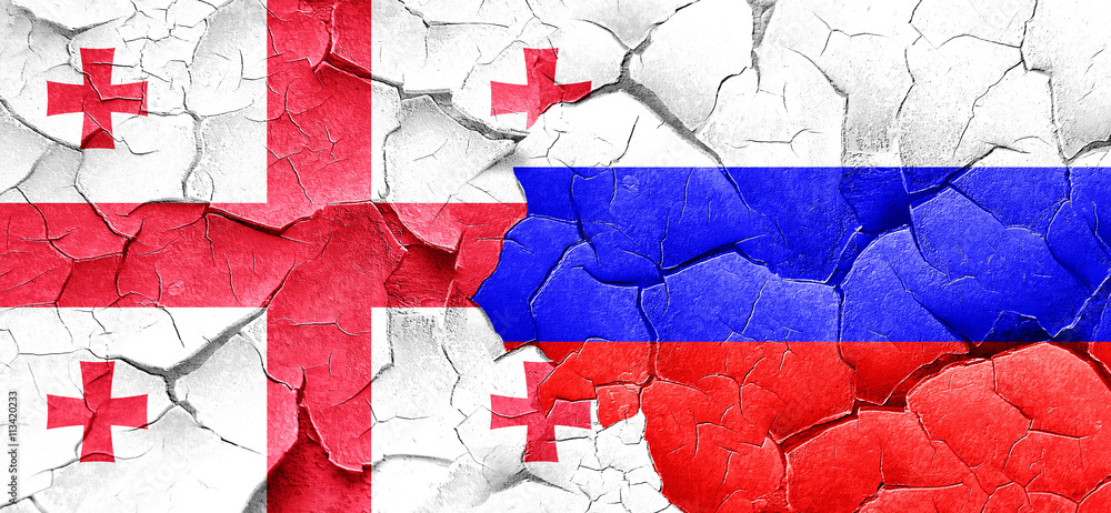 Georgia flag with Russia flag on a grunge cracked wall