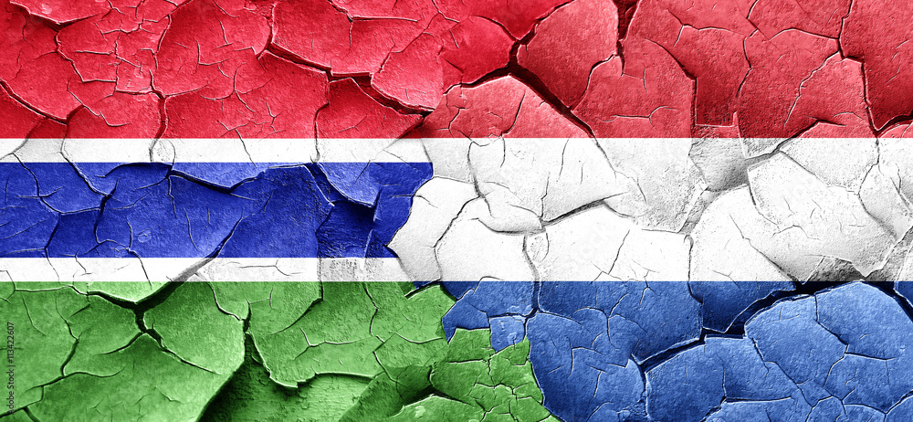 Gambia flag with Netherlands flag on a grunge cracked wall