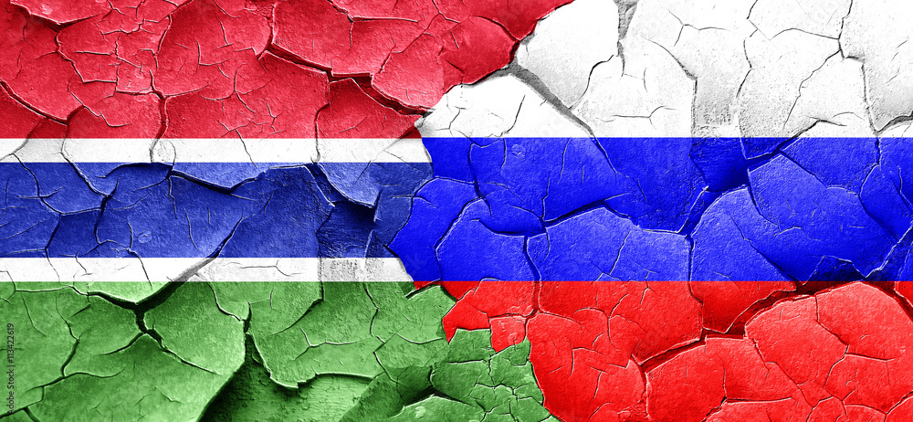 Gambia flag with Russia flag on a grunge cracked wall