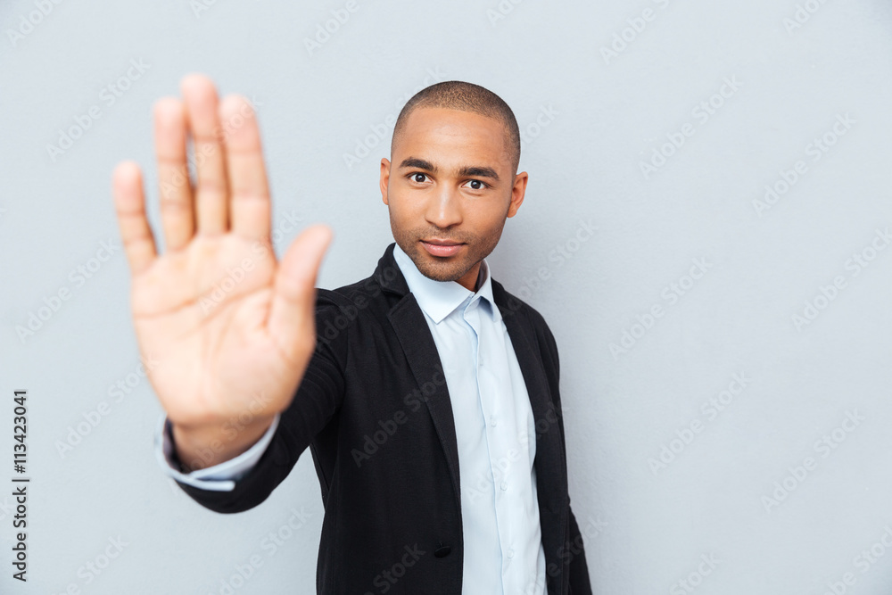 Young african man showing stop sign with hand Young african man showing stop sign with hand