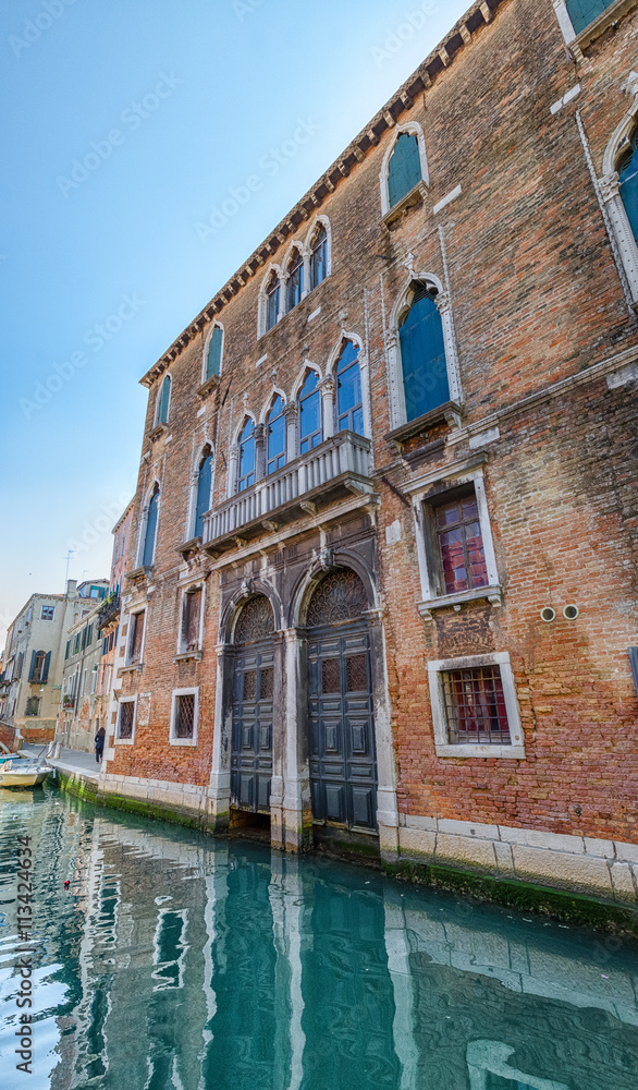 Facade of a red brick house in Venice, Italy