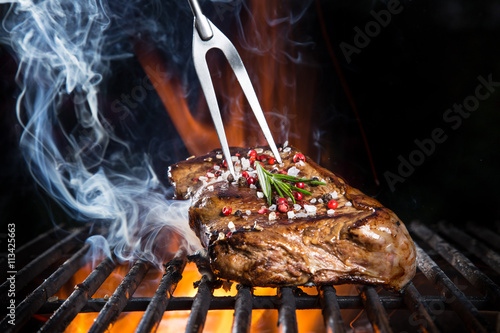 Grilled beef steak on the g...