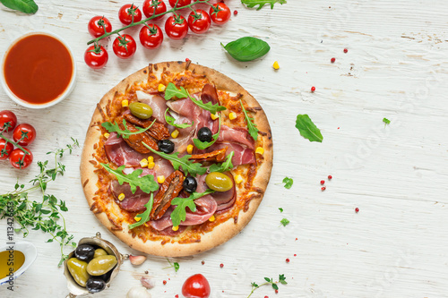 Fototapeta Naklejka Na Ścianę i Meble -  Delicious italian pizza served on wooden table