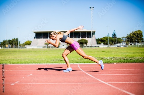 Female athlete running on the racing track