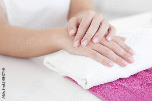 Beautiful woman hands on a towel in manicure salon