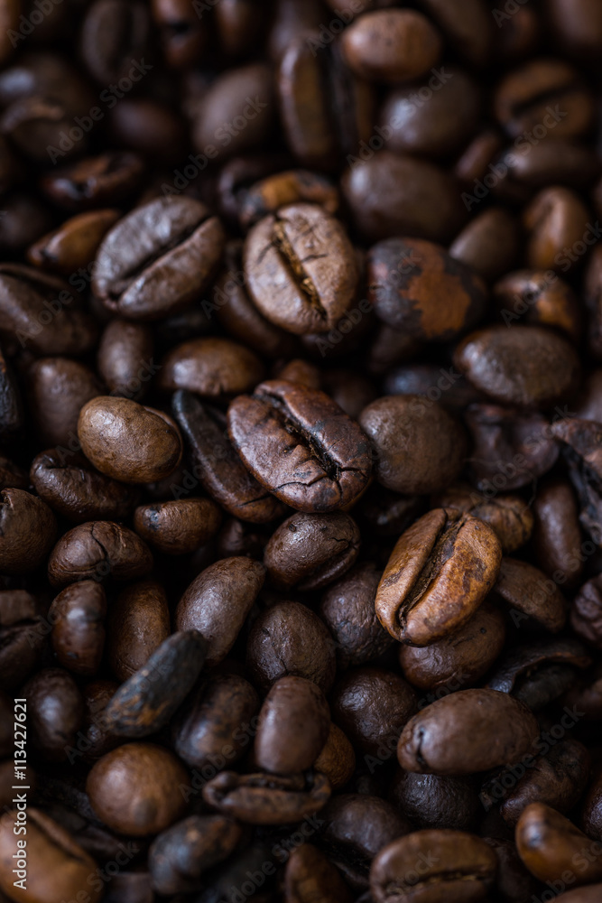 Vertical view of roasted coffee beans. Macro shot of coffee beans with selective focus. Shallow depth of field. Vertical view of roasted coffee beans. Macro shot of coffee beans with selective focus. Shallow depth of field.