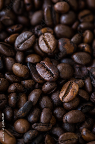 Vertical view of roasted coffee beans. Macro shot of coffee beans with selective focus. Shallow depth of field.