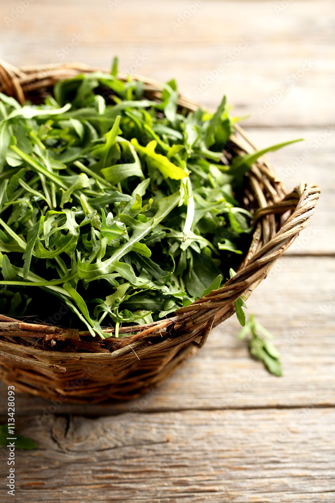 Fresh arugula leafs on a grey wooden table Fresh arugula leafs on a grey wooden table