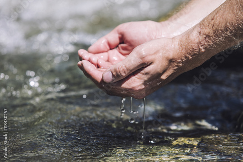 Hands sachibalaya clean water from the mountain bubbling © kuzmichstudio
