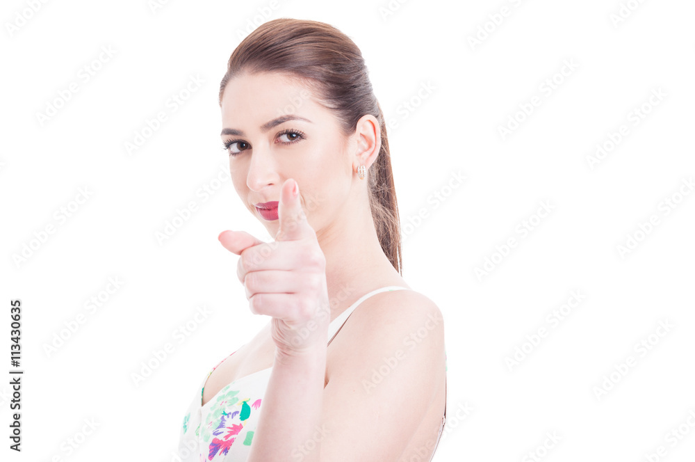 Attractive woman looking and pointing at camera with one hand Attractive woman looking and pointing at camera with one hand