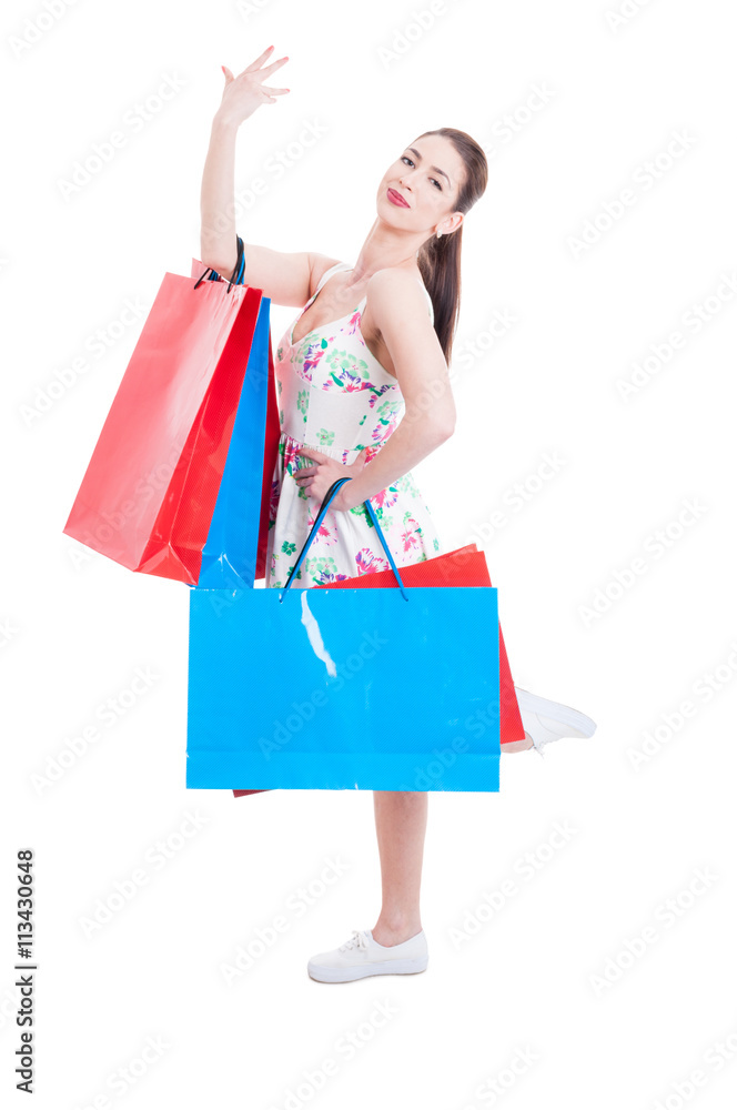 Pretty lady shopper posing with hand and leg up Pretty lady shopper posing with hand and leg up