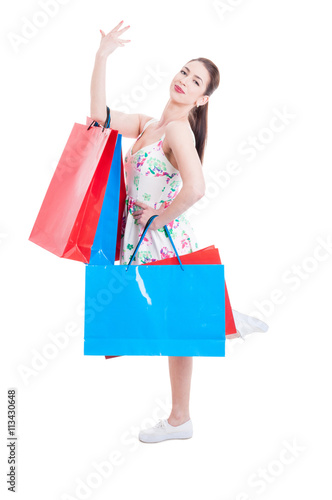 Pretty lady shopper posing with hand and leg up