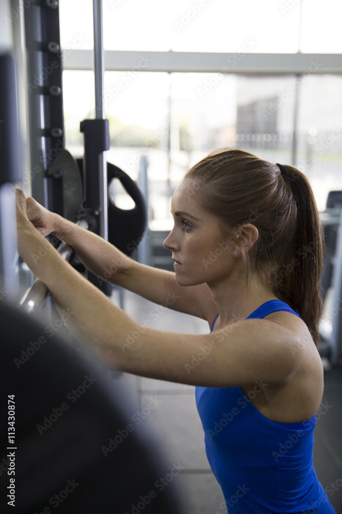 Young Woman Lifting Weights In Gym Young Woman Lifting Weights In Gym