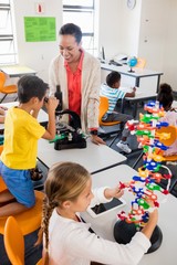 Teacher giving lesson to her students