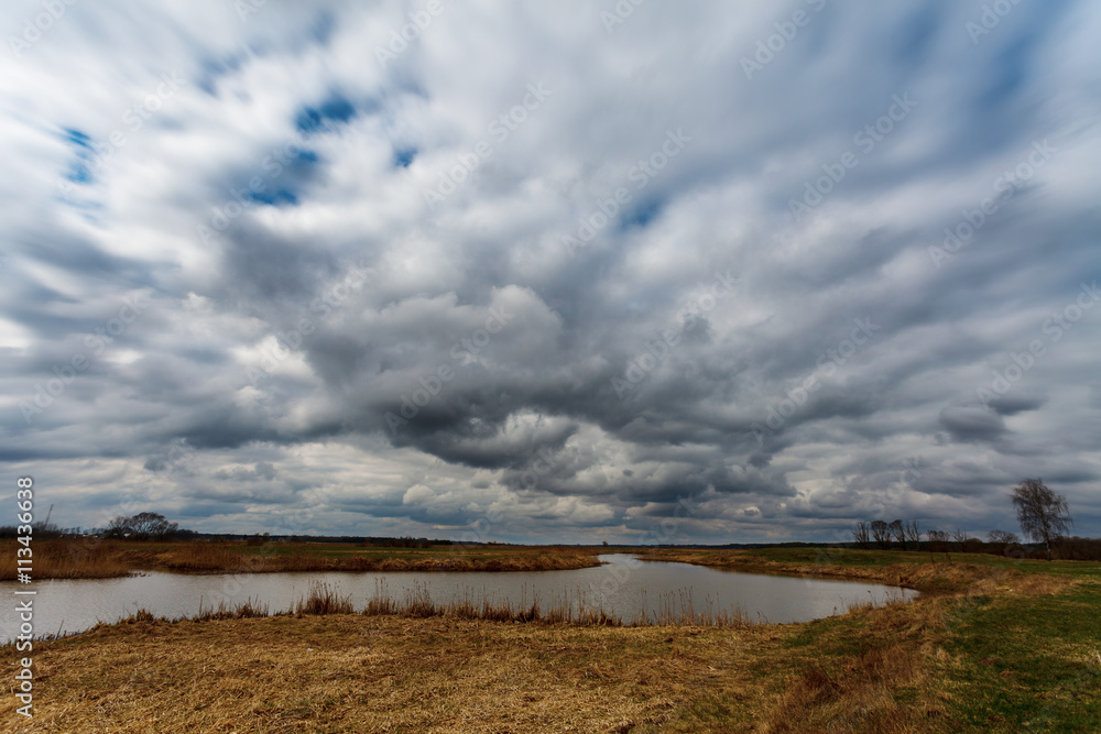 Dramatic stormy clouds over meadow