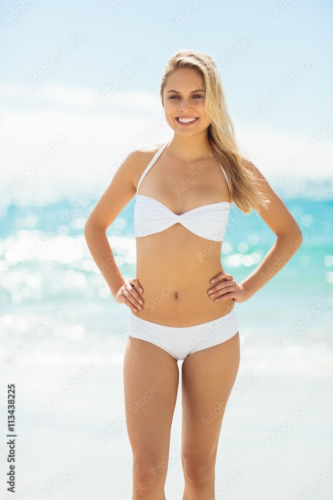 Young woman in bikini standing on beach