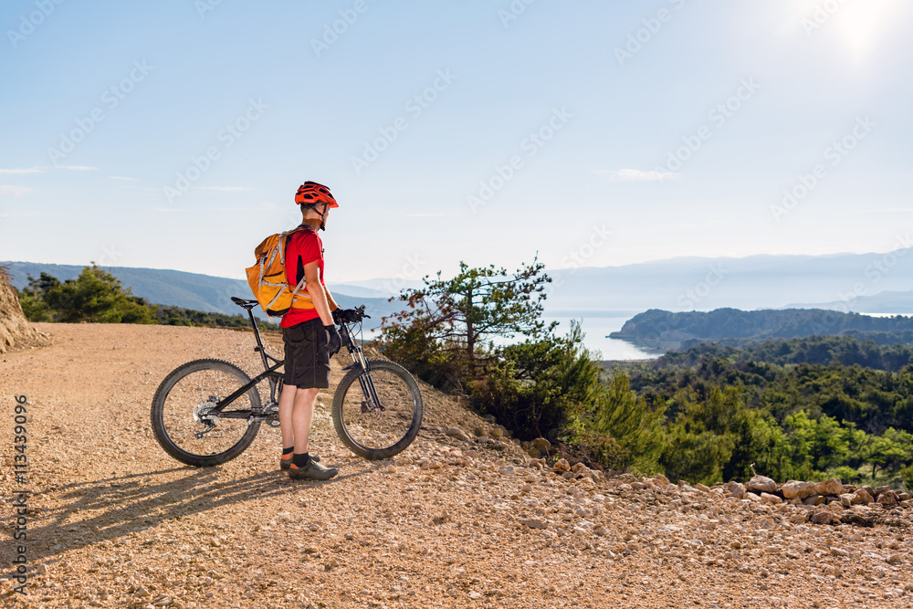 Mountain biker looking at the sea view