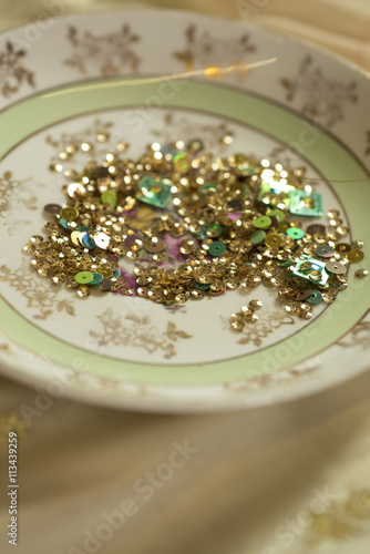 Gold and Green Sequins in Ceramic Bowl