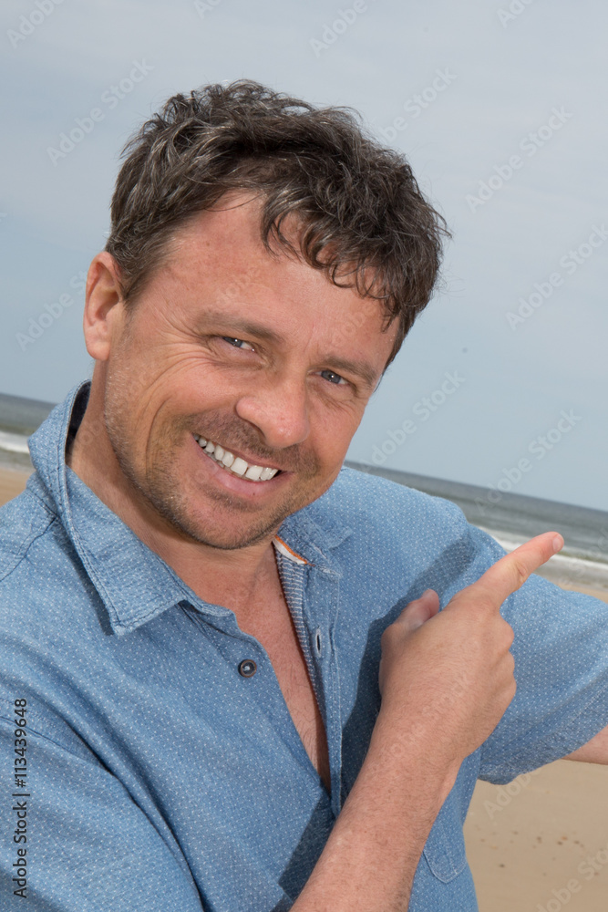 Male pointing at sea and blue sky. communication concept with mobile on ocean holiday travel. Beautiful view from terrace. Male pointing at sea and blue sky. communication concept with mobile on ocean holiday travel. Beautiful view from terrace.