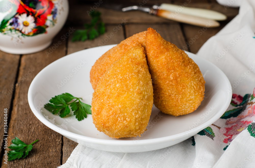 Chicken cutlets in breadcrumbs - Chicken Kiev in white bowl on wooden background. Ukrainian cuisine. Selective focus Chicken cutlets in breadcrumbs - Chicken Kiev in white bowl on wooden background. Ukrainian cuisine. Selective focus