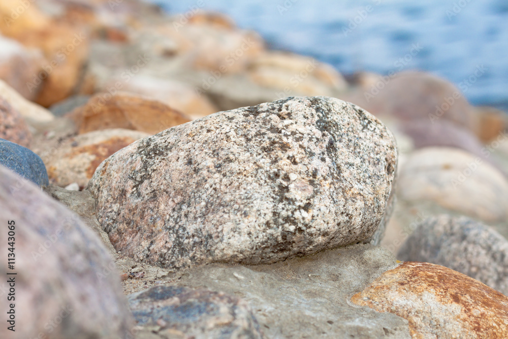 The stones on the embankment, one in focus The stones on the embankment, one in focus