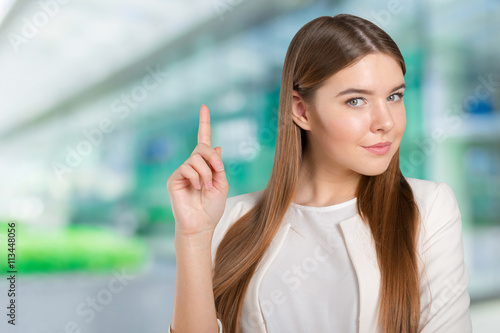 Businesswoman with finger point aside