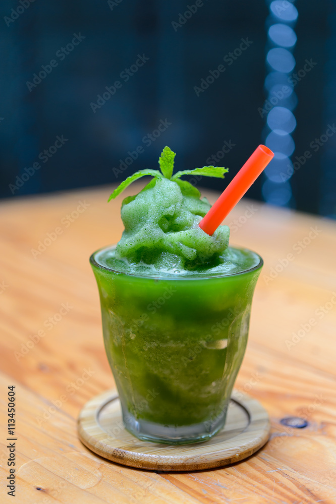 Lime mint smoothie on wooden table