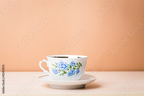 Cup of black tea in a china cup and saucer