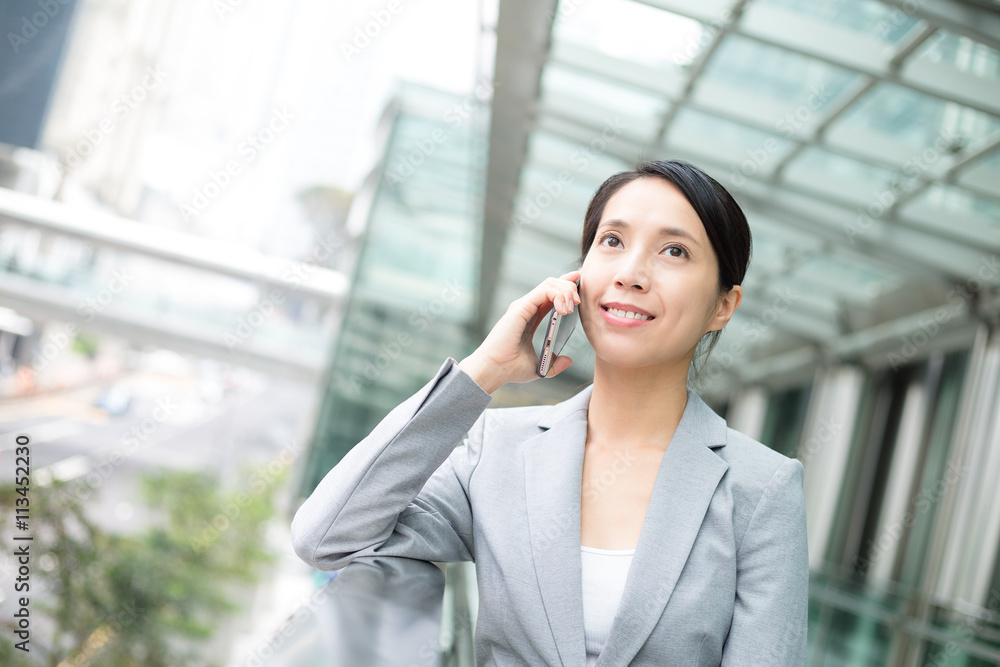 Asian woman talk to cellphone Asian woman talk to cellphone