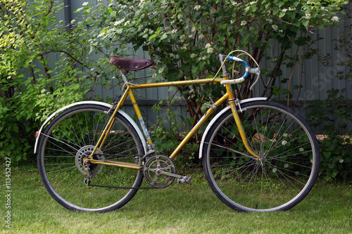 Old vintage bike. Retro road bicycle in garden.