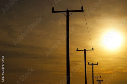 silhouette electric poles at sunset