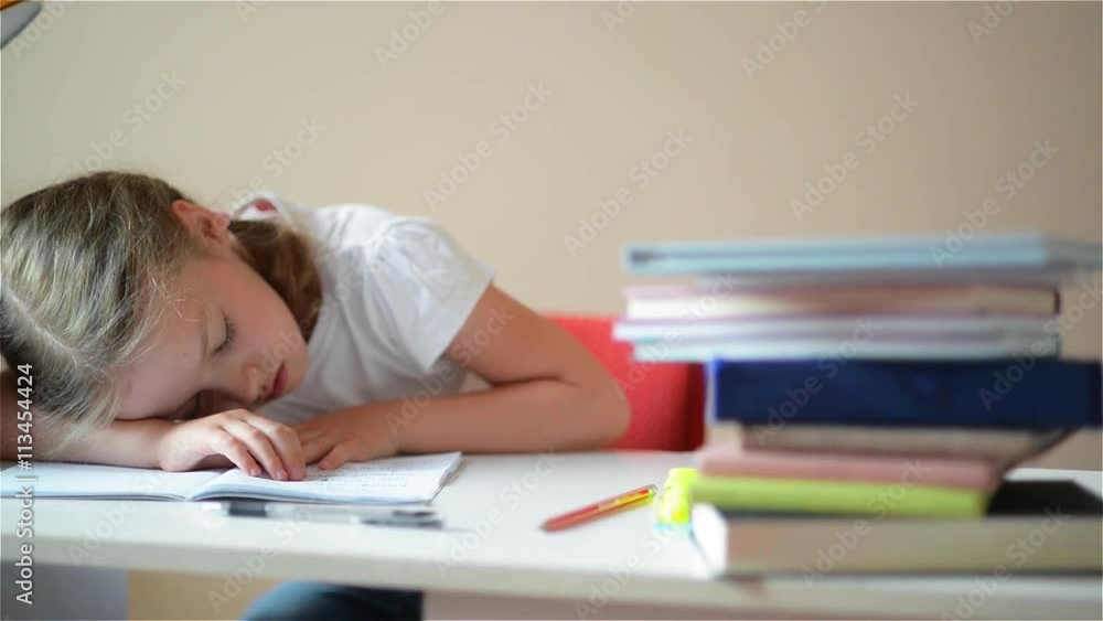 Schoolgirl learns lessons, cute girl sleeping on books Schoolgirl learns lessons, cute girl sleeping on books