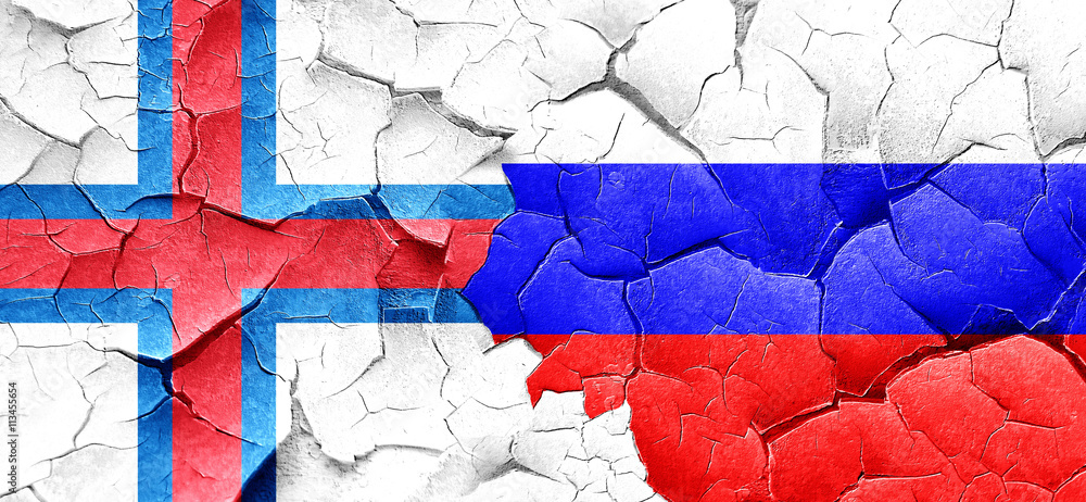 faroe islands flag with Russia flag on a grunge cracked wall faroe islands flag with Russia flag on a grunge cracked wall