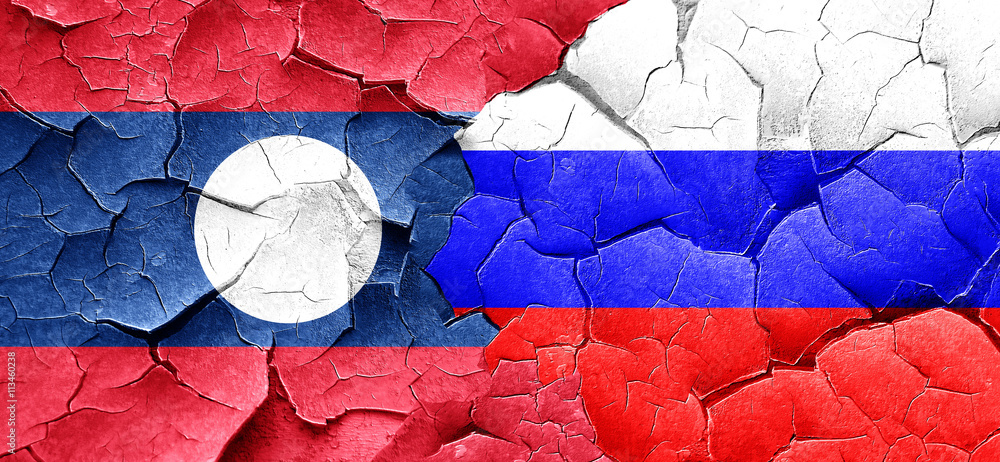 Laos flag with Russia flag on a grunge cracked wall