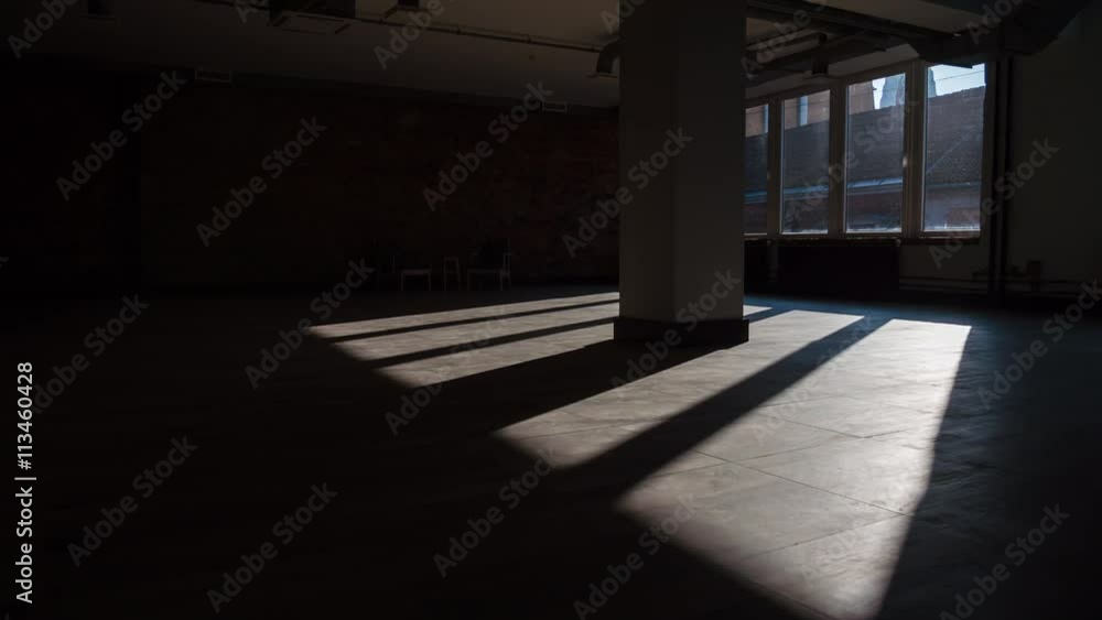 Time-lapse of sun rays moving over an empty rustic office space