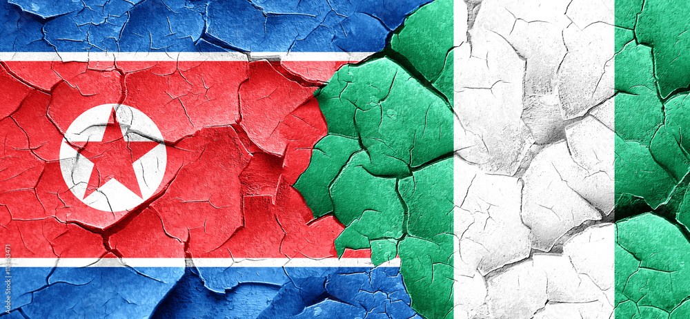 North Korea flag with Nigeria flag on a grunge cracked wall