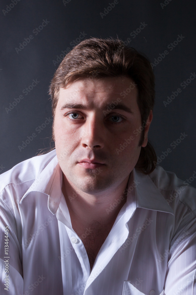 man posing in white shirt on dark background man posing in white shirt on dark background