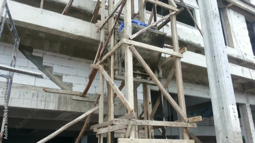 Construction lift Bucket Container Being Lift Up To The Building Construction lift Bucket Container Being Lift Up To The Building