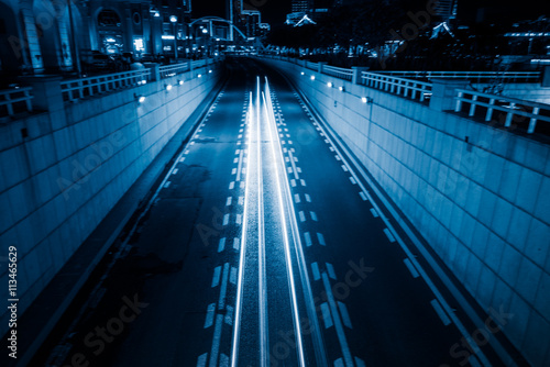 light trails with skysrapers background,tianjin china. photo