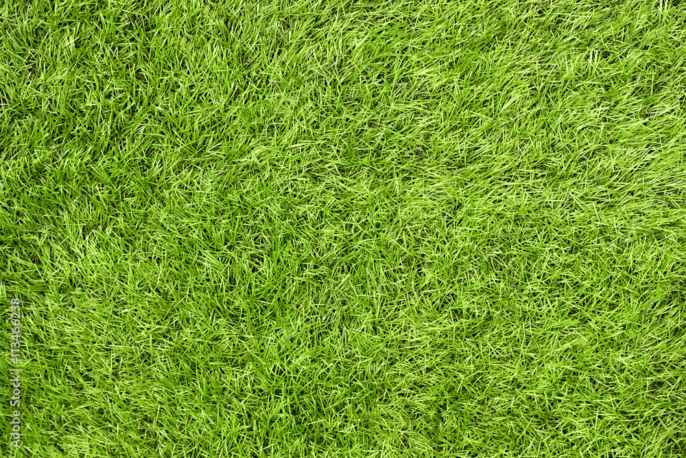 Bright green artificial grass in a football fiel Bright green artificial grass in a football fiel
