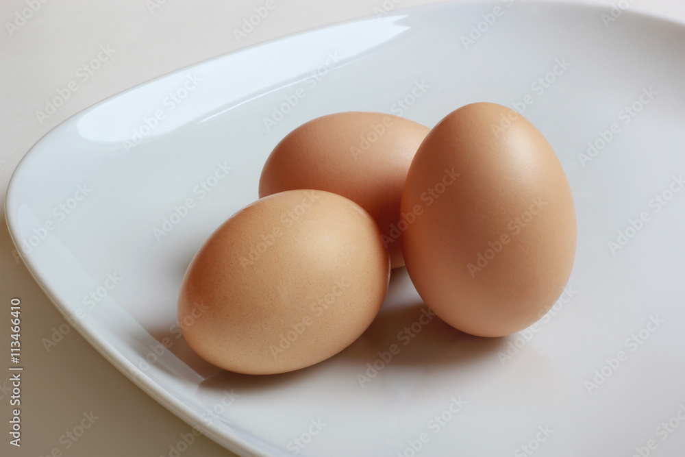 3 eggs closeup on white plate - good choice on breakfast 3 eggs closeup on white plate - good choice on breakfast