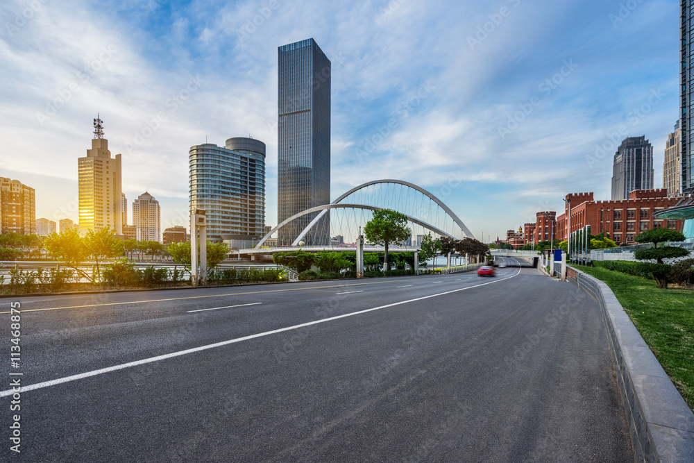 Obraz premium modern buildings with empty road under blue sky,tianjin china.