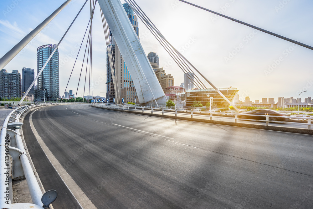 modern buildings with empty road under blue sky,tianjin china.