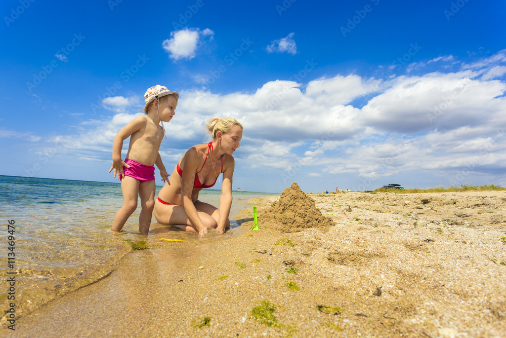 Mother and daughter building sand castle
Mother and daughter building sand castle